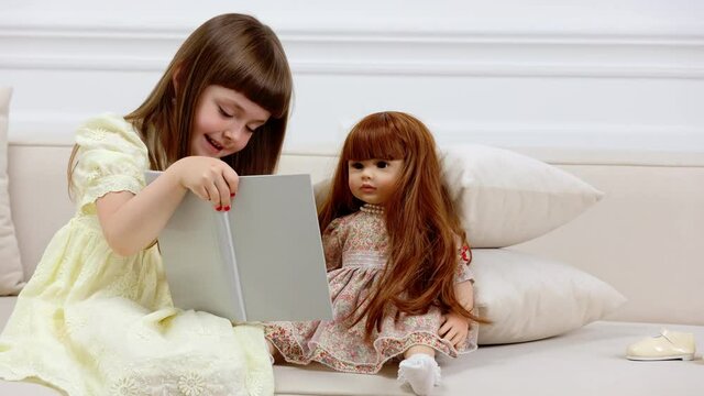 little girl playing with a doll