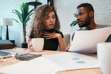Young couple planning monthly budget together.
