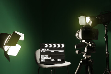Fototapeta premium Chair with clapperboard under spotlight in studio