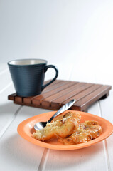 Fried banana in a plate with spoon