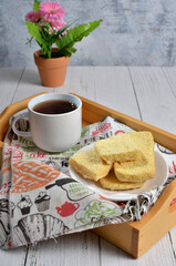 Dry bread on plate and a cup of tea