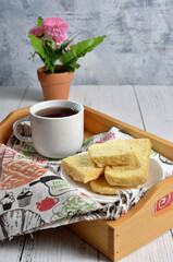 Dry bread on plate and a cup of tea