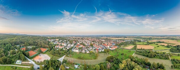 Drone panorama over German southern Hessian settlement Diedenbergen near Wiesbaden in evening light