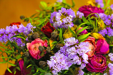 Naklejka na ściany i meble View of a bouquet of different flowers in a vase on the table.