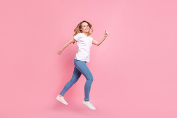 Fototapeta na wymiar Full length body size photo girl wearing stylish clothes jumping running on sale isolated pastel pink color background