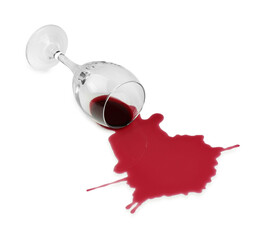 Overturned glass and spilled wine on white background