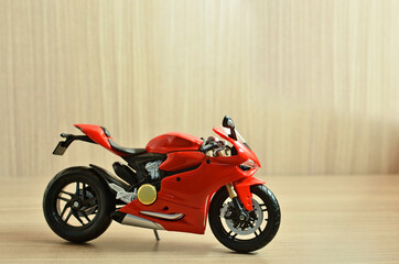 Fototapeta na wymiar Red motorcycle toy in with background