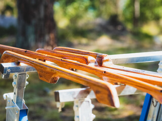 Selective focus shot of pieces of wood with newly applied varnish drying in the sun