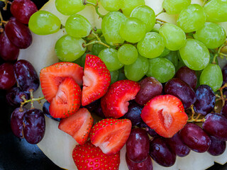 Top view of a plate with assorted fruits and berries