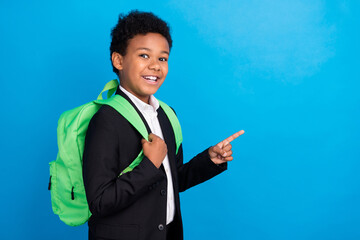 Photo of young happy positive afro american boy point finger empty space sale news isolated on blue color background