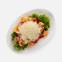 Caesar salad with chicken on a white plate
