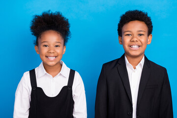 Photo of young cheerful happy positive afro american kids smile pupils good mood isolated on blue color background