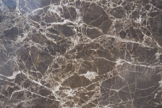 Light brown marble texture with white cracks.
