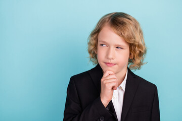 Photo of minded clever schoolboy finger chin look empty space wear uniform isolated blue color background