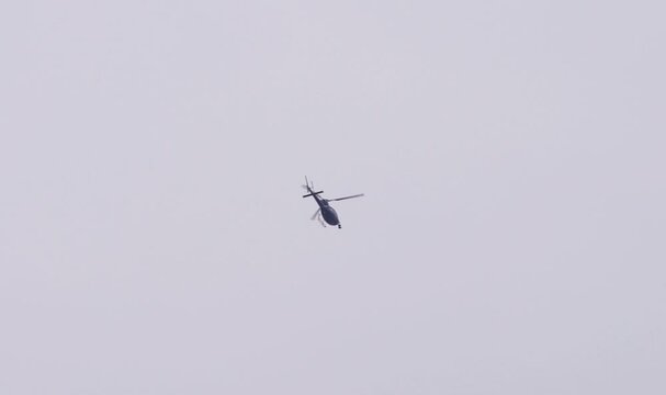 Helicopter in the sky with a huge camera attached to it to film news