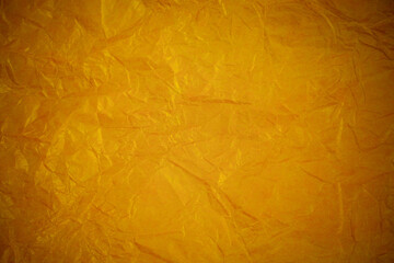 Crumpled gold paper recycling background.