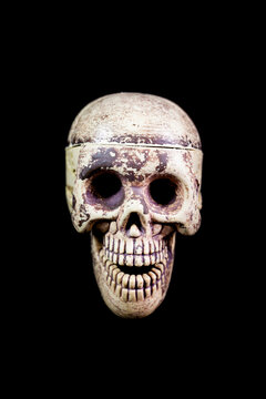 Model of human skull on black background.