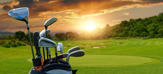 The Golf club bag and golf balls on green grass for golfer training with golf course background,green tree sun rays.	
