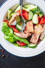 fresh salad chicken breast vegetables tomato, cucumber, lettuce diet food vitamin meal snack on the table copy space food background rustic. top view keto or paleo diet veggie 