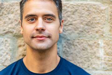 Fototapeta premium Close up portrait of smiling latin man with heterochromia