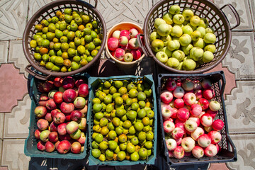 apples and pears in baskets, boxes and buckets