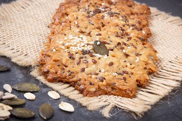 Fresh baked oatmeal cookies on jute canvas. Delicious crunchy dessert