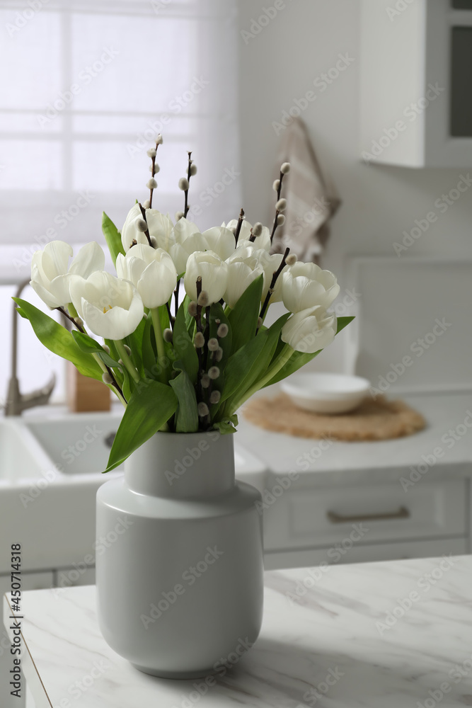 Canvas Prints Beautiful bouquet of willow branches and tulips in vase on white table indoors