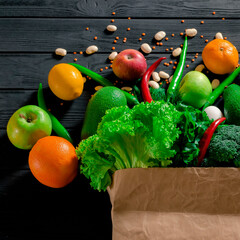 Paper bag of different tropical fresh fruits and vegetables. Healthy eating and grocery shopping concept. Top view