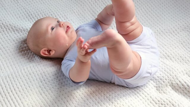 Baby regurgitates breast milk. Little baby crying and mother cleaning her cute face. Authentic Close Up Footage of Adorable Newborn Baby. Concept of Childhood, New Llife, Breast Feeding, Parenthood.