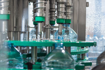 Automatic bottling drinking water in five-liter plastic bottles