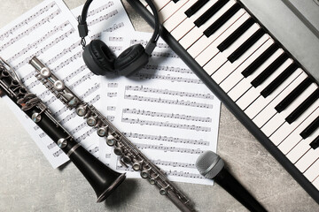 Flat lay composition with different musical instruments and microphone on light grey background