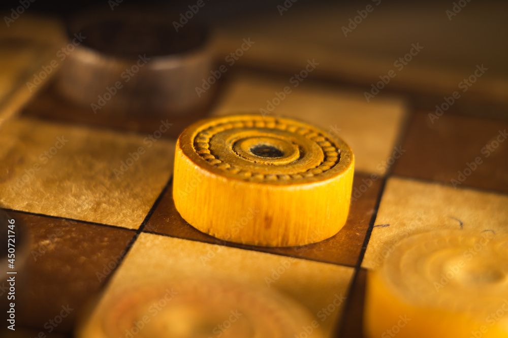 Poster closeup shot of a checkers board and wooden game pieces on it