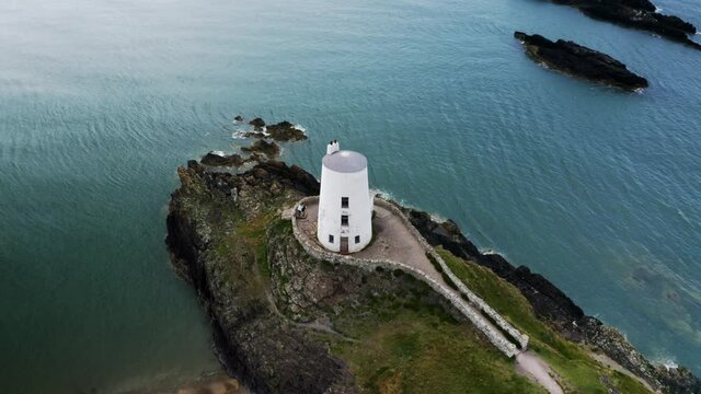 Aerial view of Twr Mawr lighthouse meaning great tower in Welsh on Ynys Llanddwyn on Anglesey Wales marks the western entrance to the Menai Strait.