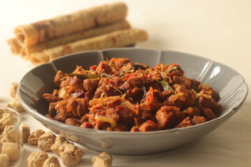 Dry roasted soya chunks with onions tomatoes and spices. Prepared with Kerala style meat masala in coconut oil. Served with indian flatbread.