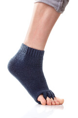 Feet with yoga toe separator socks on white background.