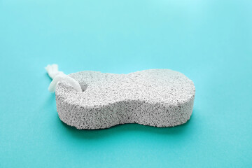 White pumice stone on turquoise background, closeup