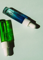 Liquid face serum in a glass bottles with a dropper. Essence of skin care for health and beauty. Copy space