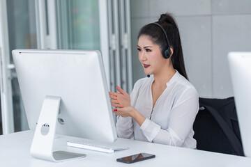 young asian woman working receiving call wear headphone consulting or solving problems for customers,Employees wearing headphones doing telemarketing