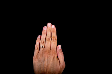 Close view of a woman hand with nails on white spots, missing vitamins, calcium on black background.