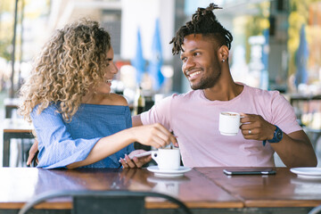Young couple drinking coffee at a coffee shop.