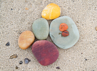 Multi-colored pebbles on the sand of a beach