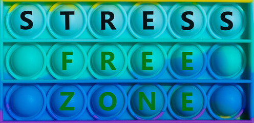 Stress free zone symbol. Words 'stress free zone' on rainbow Pop It. Beautiful background, copy space. Business, medical, psychology and stress free zone, concept.