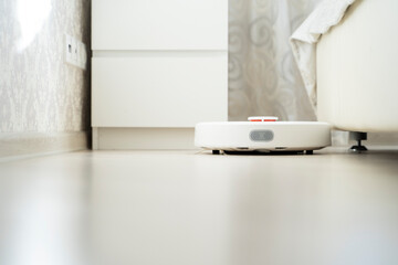 robot vacuum cleaner does cleaning in the apartment
