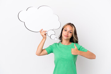 Teenager Russian girl isolated on blue background holding a thinking speech bubble with thumb up