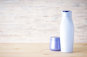 Shampoo and hair mask on a wooden background, place for text.