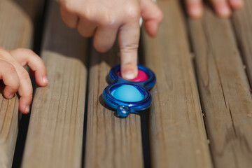 Child's hand pressing simple-dimple, Closeup