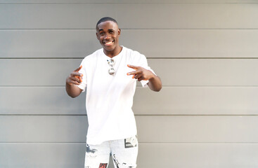 portrait of young man of color smiling at camera