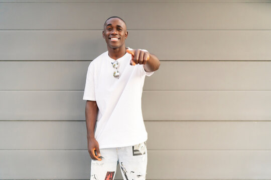 portrait of young man of color smiling at camera