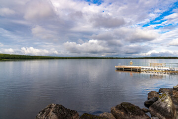 wooden floating dock and swimming platform on the shores of a calm and peaceful lake