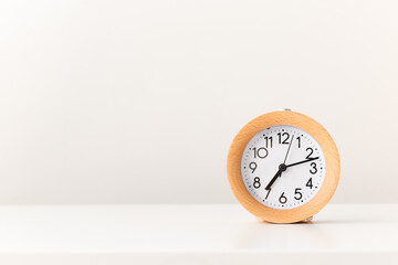 Alarm clock watch on white table background.